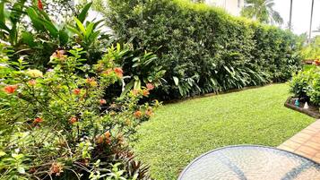 A well-maintained garden with a variety of plants and a neatly trimmed lawn.