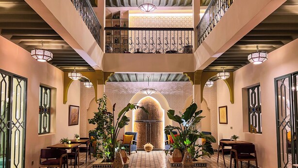 A spacious lobby with a central fountain, ornate railings, and tiled flooring. - RIAD KECH ONE & SPA (Marrakech)