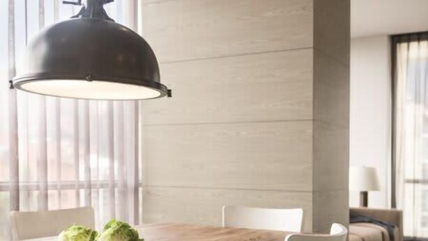 A modern dining area with a wooden table, white chairs, and a large pendant light. - w Bright 1BR w View in El Nogal (Bogotá)