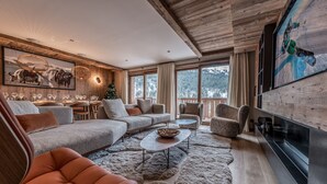 A modern living room with a sectional sofa, armchairs, a coffee table, and a fireplace. - Luxury apartment, 3 bedrooms, fireplace, concierge 5*, ski room, non-smoking (Les Allues)