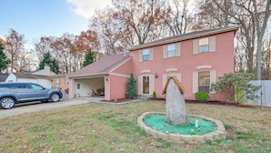 A two-story house with a garage, a small garden with a tree, and a blue car parked in front. - Dover Home Base: 3 Mi to Motor Speedway! (Dover)