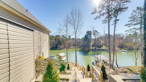 A view of a lake with a dock and a gazebo, surrounded by trees and a building with a sloped roof. - Game Room! Boater's Base on Lookout Shoals Lake (Stony Point)