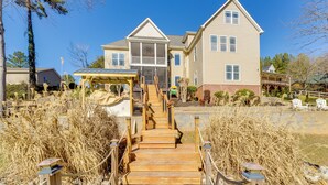 A two-story house with a covered porch and a staircase leading to the entrance. - Game Room! Boater's Base on Lookout Shoals Lake (Stony Point)