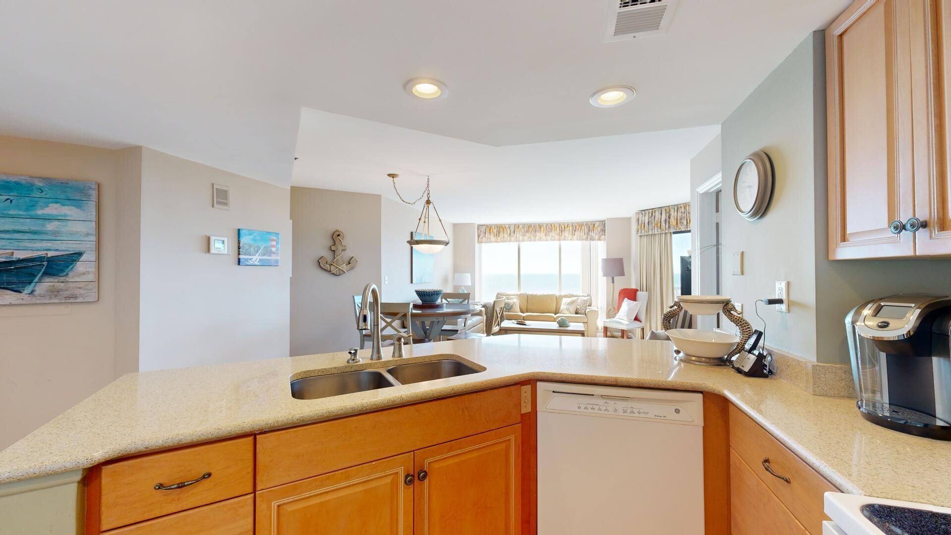 A modern kitchen with wooden cabinets, a dishwasher, and a coffee machine.