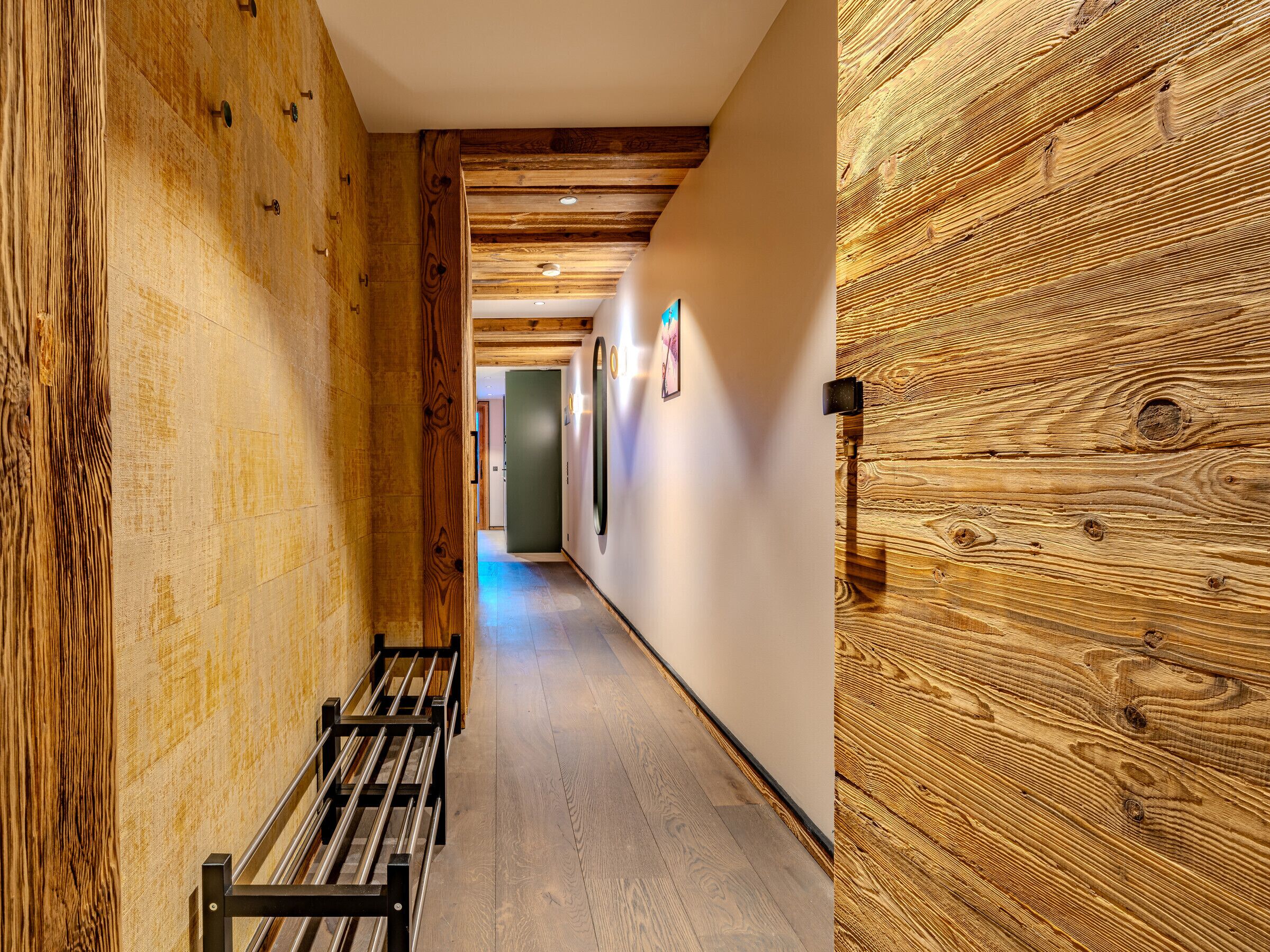 A hallway with wooden walls and benches.