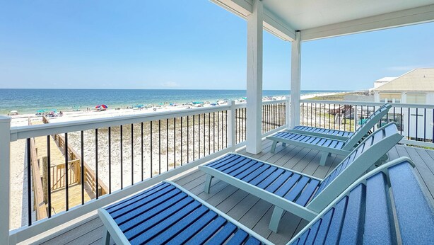 A beach view from a covered deck with blue benches and a wooden walkway leading to the beach. - NEW Aqua Vista by GSVR | Beachfront Home w/ Pool, Theater & Game Room + Free Activities/Golf (Gulf Shores)
