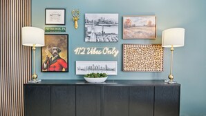 A wall with various framed artworks, a neon sign, and a decorative deer head. - 5 minutes to Stadium/Casino/PNC. Spacious house with WiFi, Game/Movie Rooms (Pittsburgh)