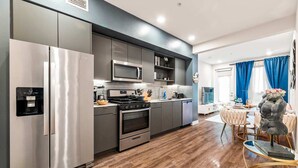 A modern kitchen with stainless steel appliances, a built-in oven, and a microwave. - Alex 2BD Haven in Hollywood!Free parking and pool! (West Hollywood)
