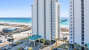A high-rise hotel with multiple floors, a beach view, and a pier in the background. - ☀️🌴 Inn at Summerwind 501 - This Is It: Wrap-Around Balcony, Near Pier 🌴☀️ (Navarre Beach)