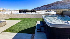 A hot tub area with a mountain backdrop. - Desert Dreams Retreat – Your Perfect Desert Getaway (3 Bedroom home & A Studio) (Moab)