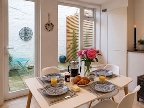 A breakfast table set with plates, croissants, and a coffee pot. - Characterful Brighton Townhouse, One Minute from the Beach (Brighton and Hove)