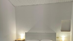 A bedroom with a bed, two bedside tables, and a nightstand. - B&B "Il Melograno" cottage with private pool in Pistoia. (Pistoia)