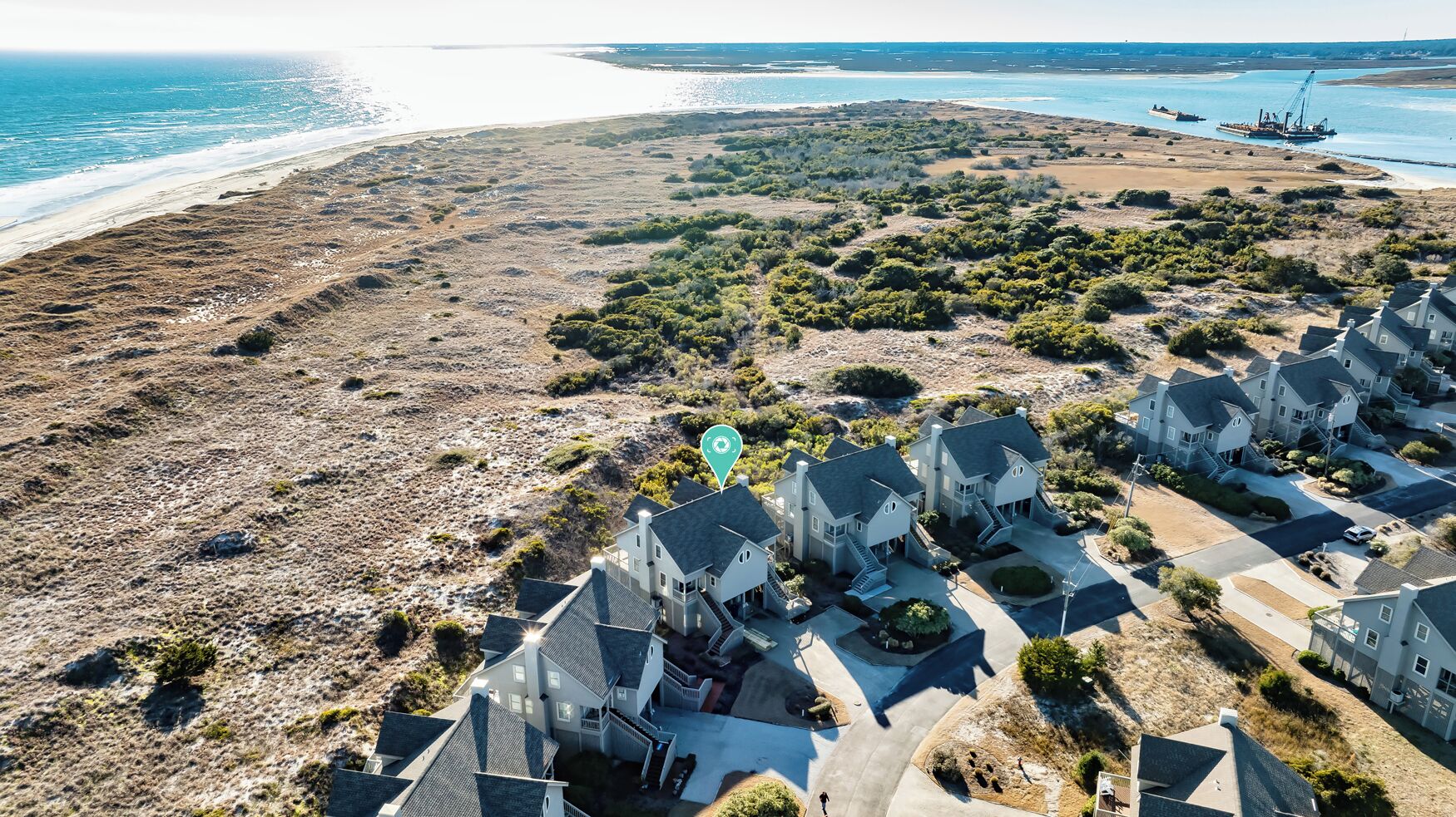 A coastal residential area with houses and a beach.