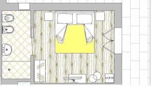 Indeling van een hotelkamer met een bed, nachtkastjes, een televisie, een zithoekje en een badkamer.