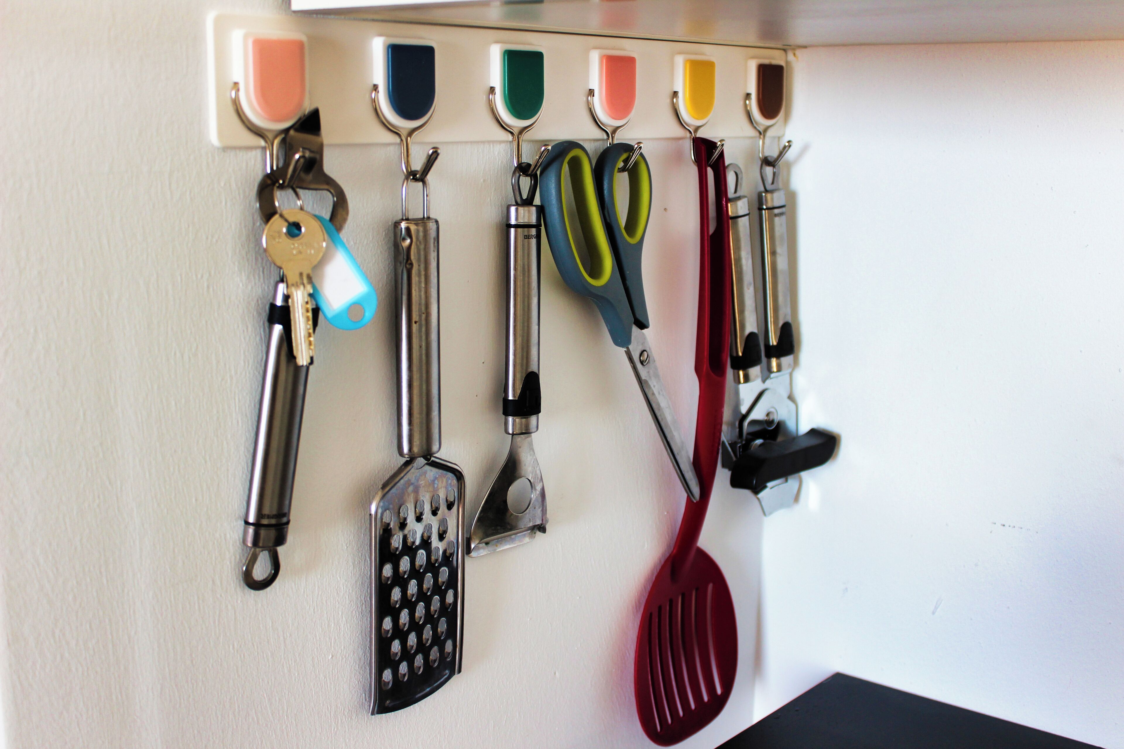 A wall-mounted key rack with various keys and tools.