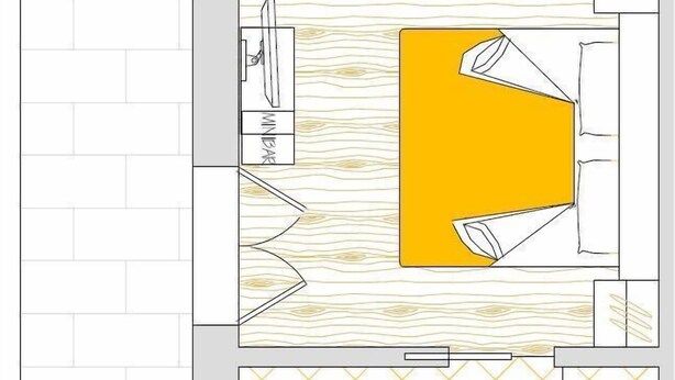 Ein Grundriss eines Hotelzimmers mit Bett, Badezimmer, einer kleinen Küchenzeile und einer Sitzecke.