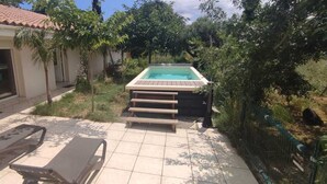 A backyard with a swimming pool, lounge chairs, and a covered patio area. - Mas Picton, 4 bedroom house with swimming pool, 10 min from the beach (Argelès-sur-Mer)