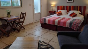 A bedroom with a bed, a desk, a chair, a sofa, and a window with a view of mountains. - Mas Picton, 4 bedroom house with swimming pool, 10 min from the beach (Argelès-sur-Mer)