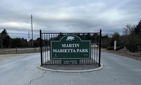 A sign for Martin Marietta Park with a bear logo, indicating a park and recreation area.