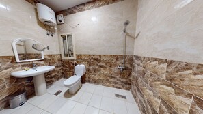A bathroom with a sink, toilet, and shower.