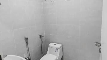 Separate bathtub and shower, towels, soap, shampoo