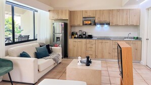 A modern kitchen with wooden cabinets, a built-in microwave, and a stainless steel refrigerator. - Discover Coronado's Best Area with Pool (Panamá Oeste Province)