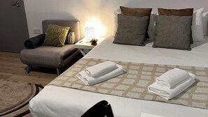 Une chambre d’hôtel avec un lit, une chaise, un bureau et une œuvre d’art représentant un zèbre accrochée au mur.