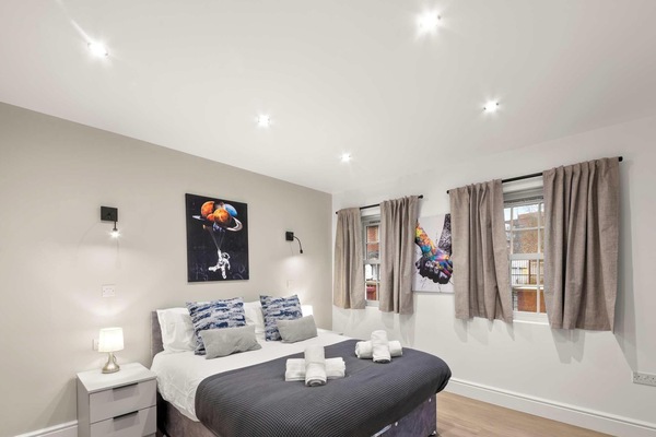 A peaceful bedroom designed for rest and relaxation, with soft bedding and a calm atmosphere that invites you to unwind after a long day.