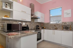 Fridge, microwave, oven, stovetop - Minimalism Muse | Chic Sea Point Apartment (Cape Town)