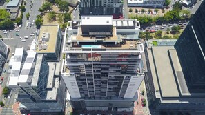 A high-rise building with a modern architectural design, featuring multiple floors and a central courtyard. - Highest Penthouse in City - Pool and Panoramic Views (Cape Town)