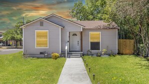 A single-story house with a front door, two windows, and a small porch. - Waco Oasis | 5 min to downtown, Magnolia, & Baylor (Waco)