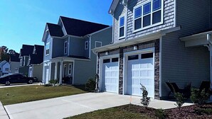 A suburban house with a front yard, a yellow fire hydrant, and a clear blue sky. - Simple Elegant Single Fam Home < DT Raleigh NCSU (Raleigh)