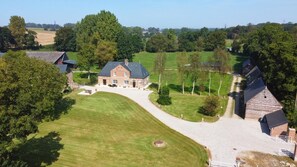 Experience a serene country retreat surrounded by expansive lawns and mature trees.