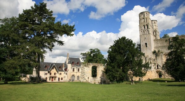 A historic building with a large tower and a smaller building with a gabled roof.