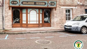 A two-story brick building with a bakery named "M' ROSE" on the ground floor. - Gîtes de France® - Chez Mlle Rose (VEULES LES ROSES)