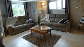 A living room with two sofas, a coffee table, and a lamp.