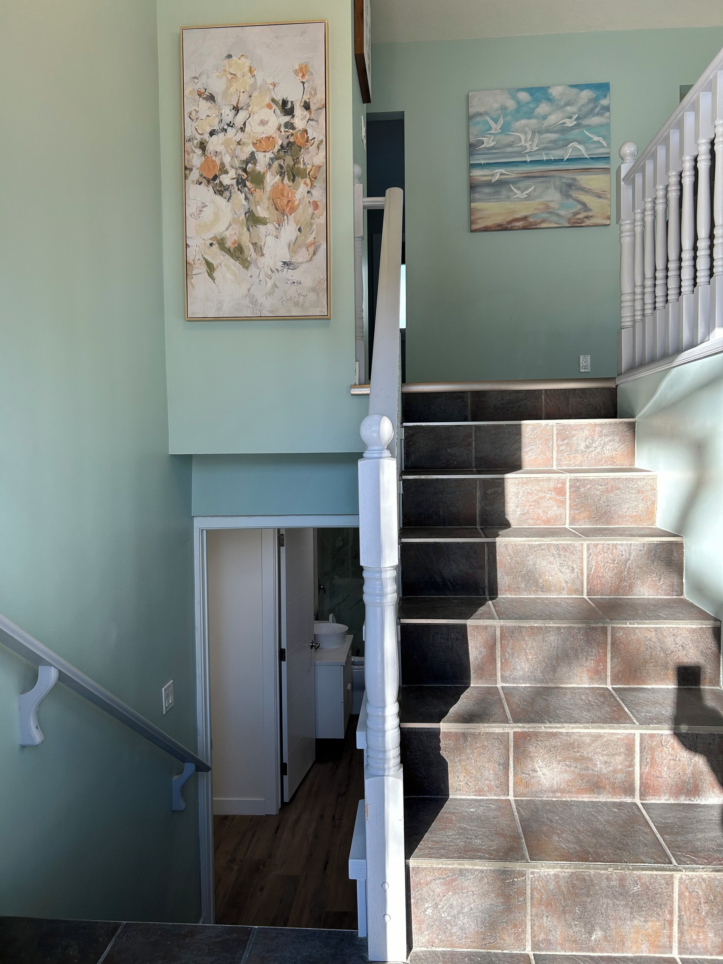 A staircase with a white balustrade leading to a second floor.