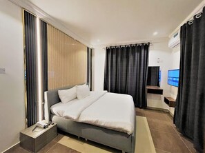 Relax in comfort with a large bed and flat-screen TV.