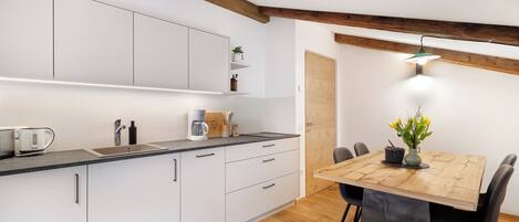 Fridge, stovetop, dishwasher, coffee/tea maker