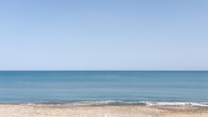 A beach with clear skies and calm water.