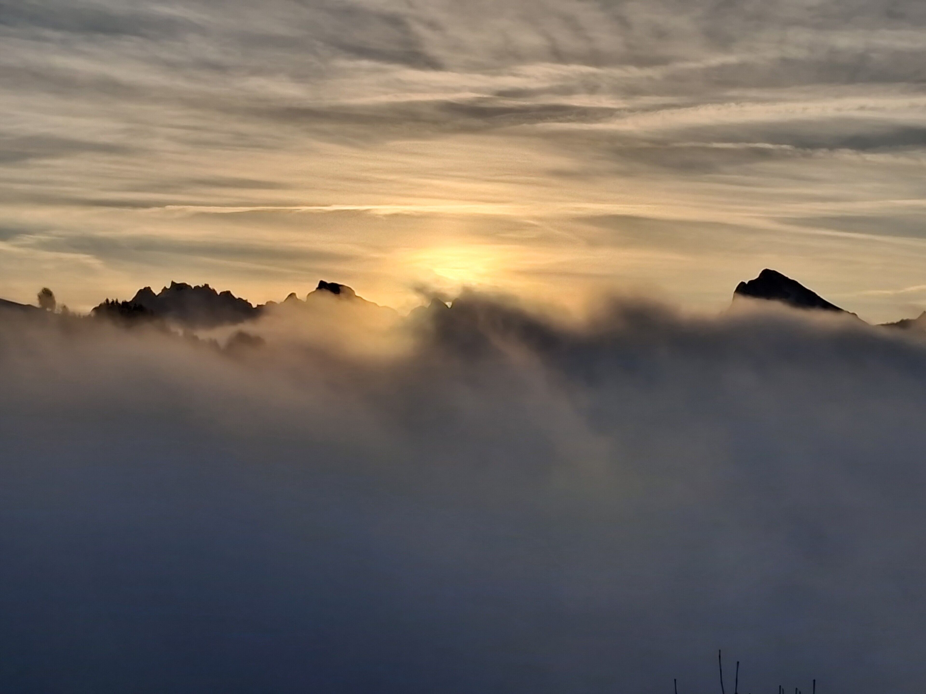 A mountain landscape with clouds and sunlight.