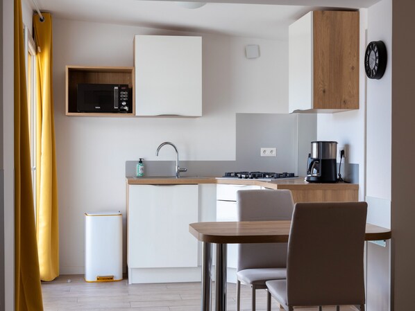 Fridge, microwave, stovetop, coffee/tea maker