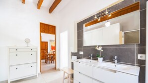 A modern bathroom with a double sink vanity, a large mirror, and a wooden ceiling. - Villa 'Pascual Gran' with Mountain View, Private Pool and Wi-Fi (Manacor)