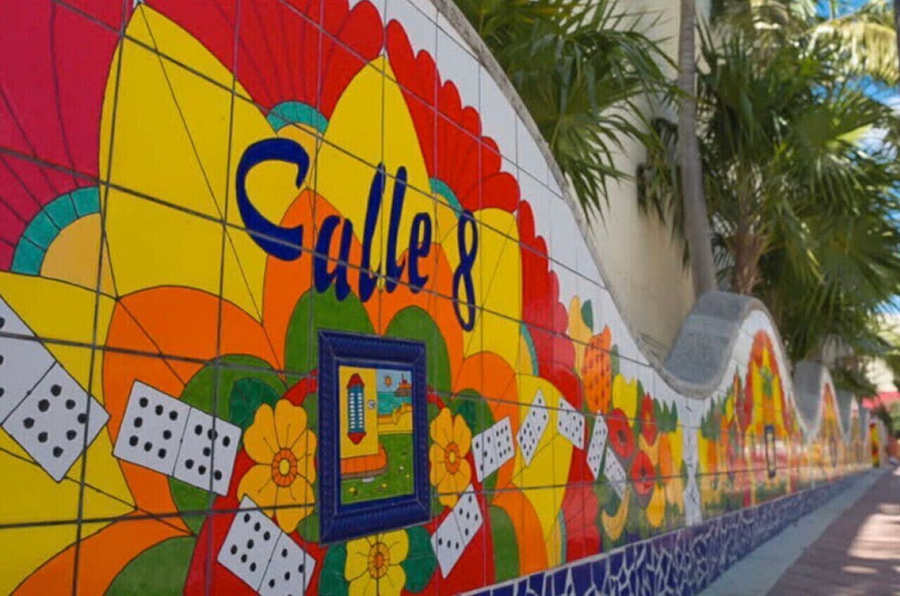 A colorful mural with the text "Calle 8" and a depiction of a street scene.