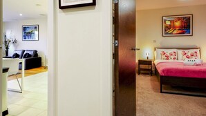 A hotel room with a bed, a nightstand, a lamp, and a painting on the wall. - City Centre | Cathedral Quarter | Walk Everywhere - Pass the Keys (Belfast)