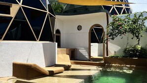 A pool area with geometric architecture, a clear pool, and a shaded outdoor space. - The Dome Villa Canggu (Canggu)
