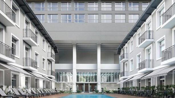 A modern hotel with a central pool, multiple balconies, and a clean, contemporary design. - MOT Azopardo 700 (Buenos Aires)