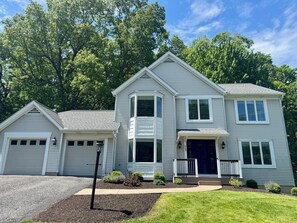 A two-story house with a garage, a front porch, and a well-maintained lawn. - Happy Valley Retreat ~ Epic Game Room ~ 130" TV Wall ~ 10 min to Campus/Downtown (State College)