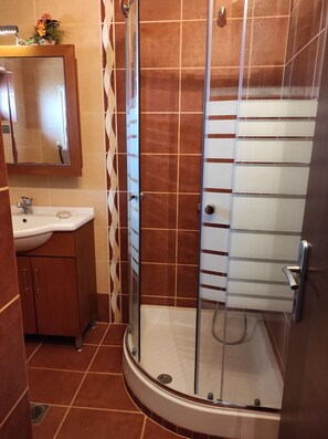 A bathroom with a shower, sink, and mirror. - Villa Traditional Estate Heated Pool (Nea Propontida)