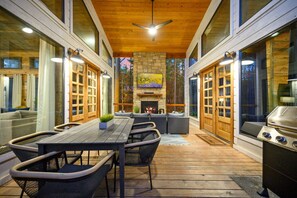 An outdoor patio with a wooden table, chairs, and a grill. - Chillin` N` Grillin` · Cozy Retreat: Game Room, Fire Pit & BBQ Haven (Broken Bow)